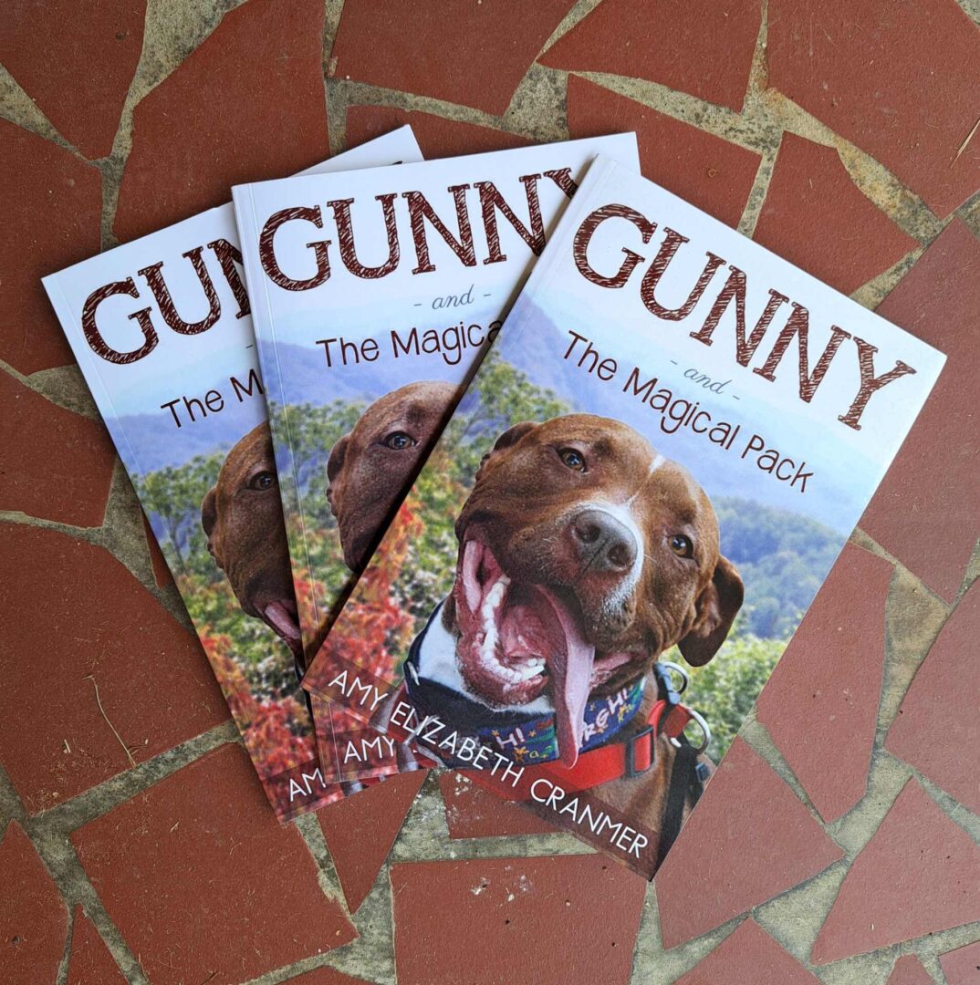 Three books about dogs on a table.